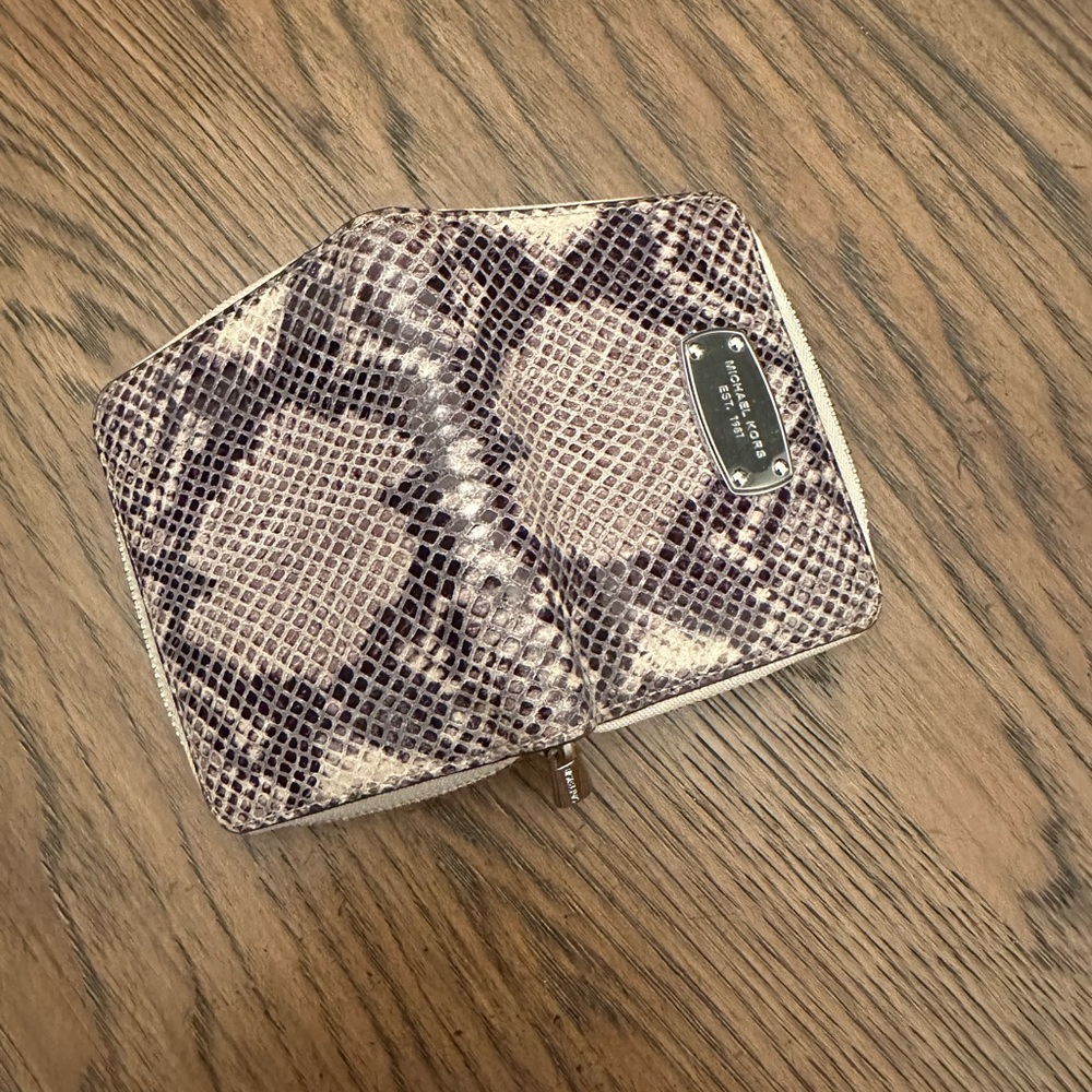 Used- in good condition. Gray, cream, snake skin Michael Korda wallet.